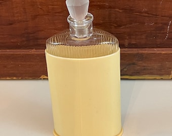 Botella de perfume amarilla vintage