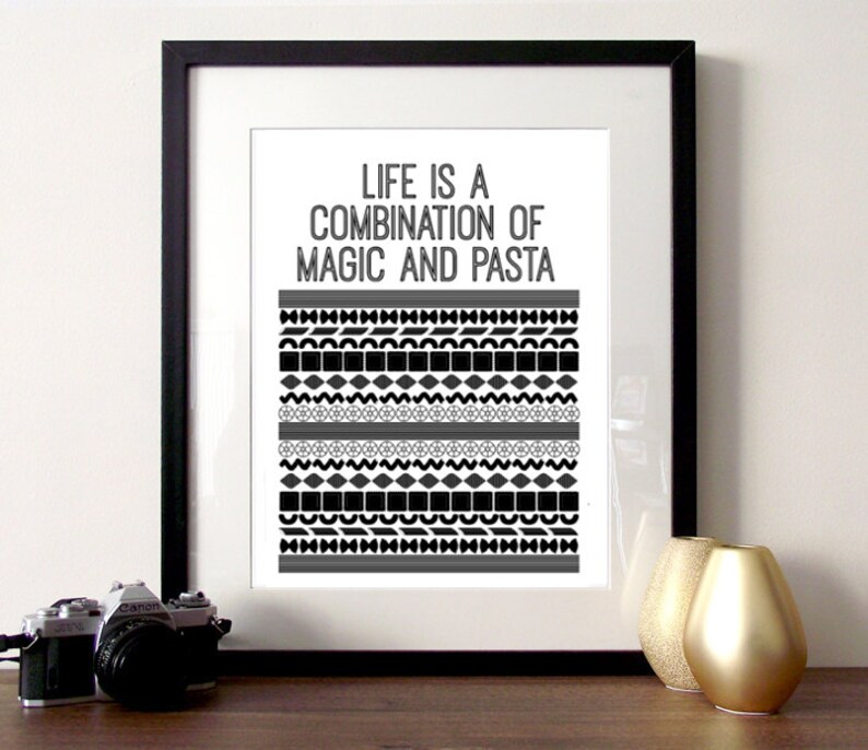 May include: Black and white framed print with the text "Life is a combination of magic and pasta" and a black and white geometric pattern.