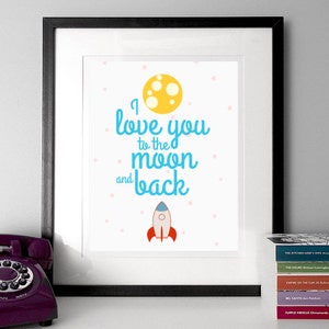 May include: A white framed print with a blue and yellow design. The print says "I love you to the moon and back" with a yellow moon and a blue rocket ship.
