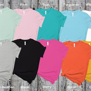 May include: Ten blank t-shirts in various colors, including mint, pink, teal, turquoise, white, athletic heather, black, berry, coral, and gold.