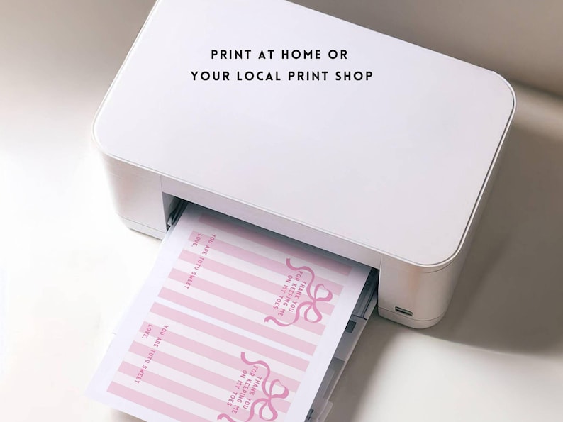 May include: A white printer with a sheet of paper coming out of it. The paper has pink and white stripes and text that says "FOR KEEPING ME ON MY TOES THANK YOU" and "YOU ARE TOO SWEET". The text on the printer says "PRINT AT HOME OR YOUR LOCAL PRINT SHOP".