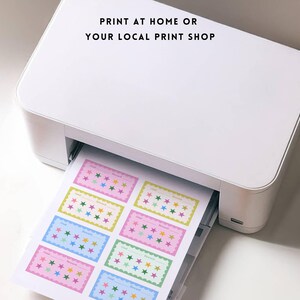 May include: A white printer printing colorful star-themed cards. The cards have a rectangular shape with a scalloped border and the text "Print at home or your local print shop". The cards are in various pastel colors.