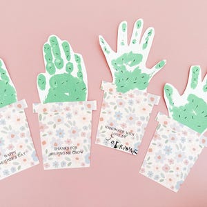 Completed handprint art showing its cut-out handprint cactus attached to the printed floral pot. A sentimental keepsake perfect for mother's day or grandma gift