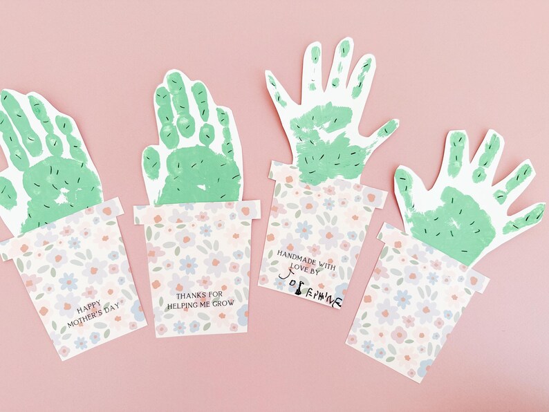 Completed handprint art showing its cut-out handprint cactus attached to the printed floral pot. A sentimental keepsake perfect for mother's day or grandma gift