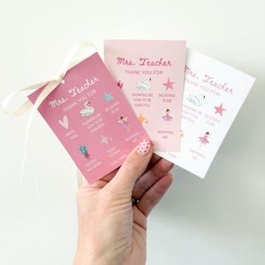 May include: Three pink teacher thank you cards with a white ribbon. Each card has the text "Mrs. Teacher THANK YOU FOR" and includes illustrations of a swan, star, and ballerina. The cards also have phrases like "Showing me how to be graceful" and "Inspiring me."