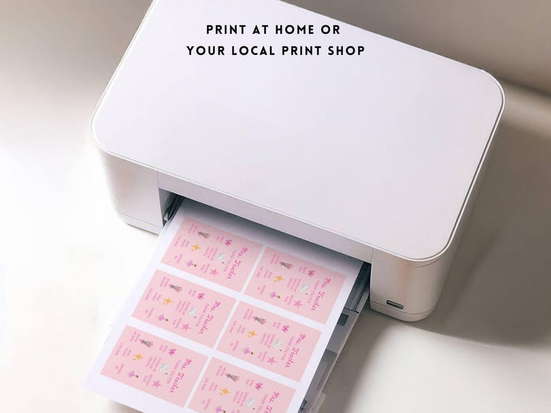 May include: A white printer printing sheets of pink labels. The labels have text and illustrations. The text on the image reads: "PRINT AT HOME OR YOUR LOCAL PRINT SHOP."