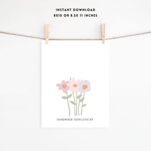 May include: Printable art print featuring a simple illustration of three pink and purple flowers with green stems. The text "Handmade with love by" is at the bottom of the print.