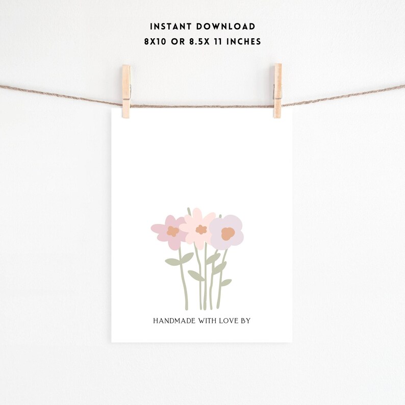 May include: Printable art print featuring a simple illustration of three pink and purple flowers with green stems. The text "Handmade with love by" is at the bottom of the print.
