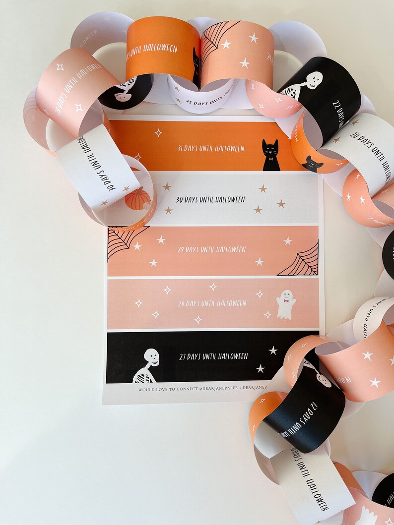 May include: A printable Halloween countdown chain with orange and pink paper links. Each link features a different Halloween character and the number of days until Halloween. The text on the chain reads "Days Until Halloween".