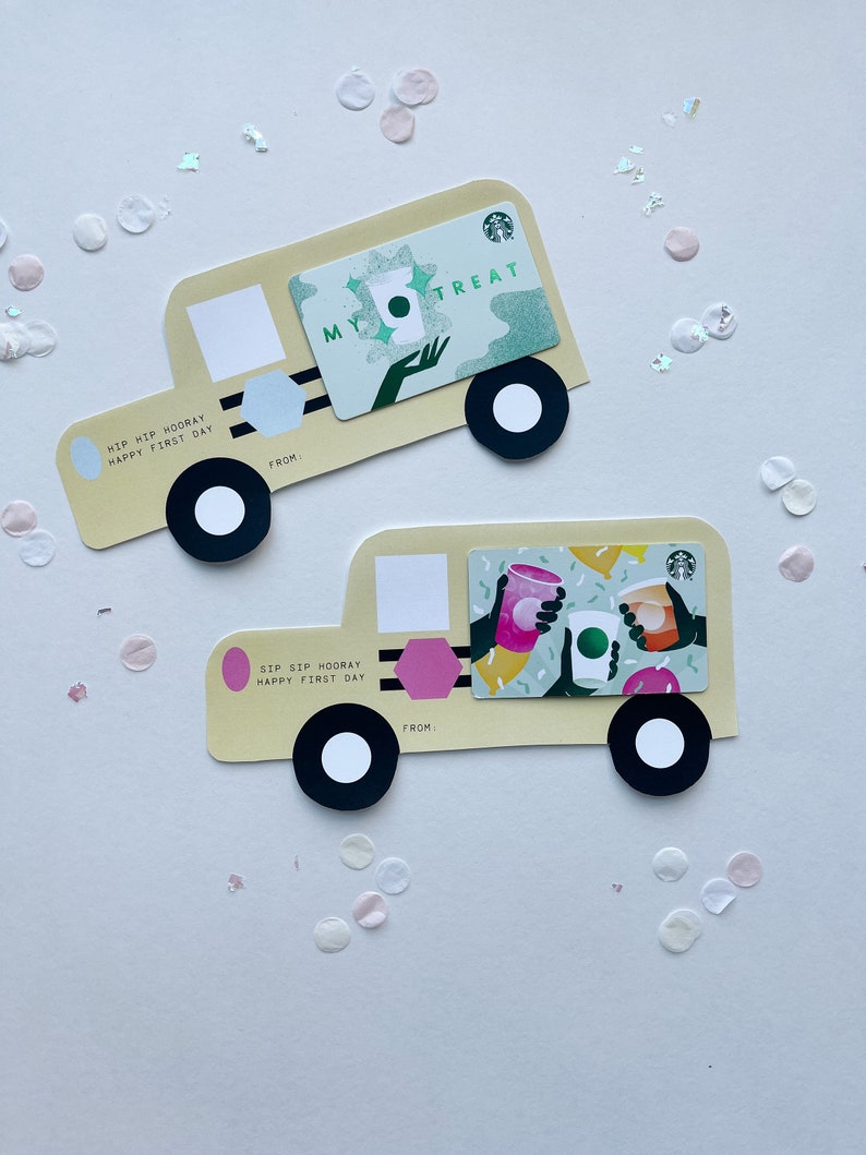 May include: Two yellow paper cut-out trucks with black wheels. The top truck has a green gift card with the text "My Treat" and a green Starbucks logo. The bottom truck has a pink gift card with the text "Sip Sip Hooray Happy First Day".