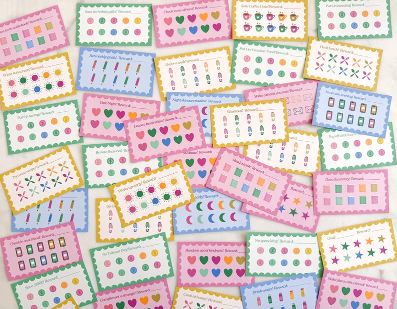 May include: A collection of colorful reward cards with various designs and text. The cards feature scalloped edges and are decorated with hearts, stars, and other shapes. The text on the cards includes phrases like "Date Night Reward" and "Workout Reward".