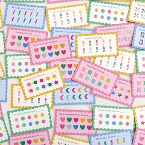 May include: A collection of colorful reward cards with various prompts and illustrations. Each card features a unique design, including hearts, pencils, footprints, and more. The cards are in shades of pink, blue, green, and yellow.