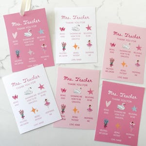 May include: A collection of pink and white "Mrs. Teacher Thank You" cards. Each card features a swan, star, and ballerina graphic, along with phrases like "Being Kind" and "Inspiring Me." A cream ribbon is attached to one card.