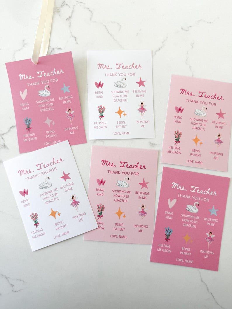 May include: A collection of pink and white "Mrs. Teacher Thank You" cards. Each card features a swan, star, and ballerina graphic, along with phrases like "Being Kind" and "Inspiring Me." A cream ribbon is attached to one card.