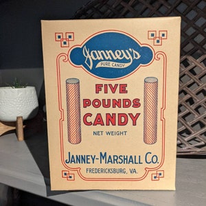 May include: A vintage cardboard box for Janney's Pure Candy. The box is brown with blue and red accents. It features the text "Janney's Pure Candy", "Five Pounds Candy", "Net Weight", "Janney-Marshall Co.", and "Fredericksburg, VA.".