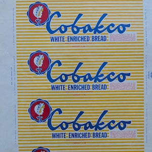 May include: Vintage Cobakco White Enriched Bread packaging. The design features a repeating pattern of yellow and white horizontal stripes. The text "Cobakco White Enriched Bread" is in blue script, with a red and blue emblem. Weight: 1 lb.