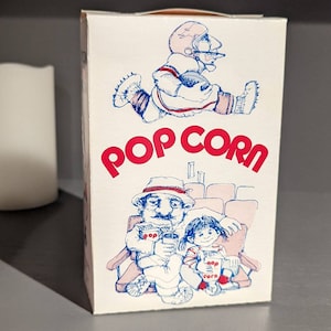 Caja de palomitas de maíz con boceto original de los años 80 de NOS