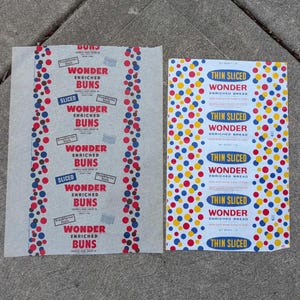 May include: Two vintage paper wrappers. One features the text "WONDER ENRICHED BUNS" in red, with blue and red polka dots. The other wrapper reads "THIN SLICED WONDER ENRICHED BREAD" with blue, yellow, and red polka dots.