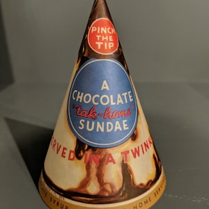 May include: A vintage paper cone for a chocolate sundae, featuring the text "Pinch the Tip" and "A Chocolate "tak-home" Sundae" with a picture of a sundae served in a cone.