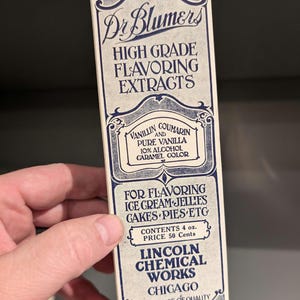 May include: A vintage box of Dr. Blumers High Grade Flavoring Extracts, with a blue and white design. The box states that the contents are 4 ounces and the price is 50 cents. The box is from Lincoln Chemical Works in Chicago, Illinois.