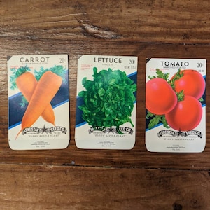 May include: Three vintage seed packets for carrots, lettuce, and tomatoes. Each packet features a colorful illustration of the vegetable and the text "Lone Star Seed Co. Every Seed A Plant".