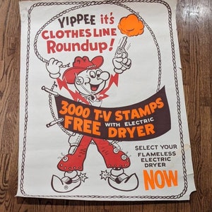 May include: A vintage poster advertising a free electric dryer with the purchase of 3,000 TV stamps. The poster features a cartoon cowboy holding a lasso and a gun, with the text "YIPPEE it's CLOTHES LINE Roundup!" and "SELECT YOUR FLAMELESS ELECTRIC DRYER NOW".