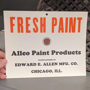 May include: A vintage sign with the words "FRESH PAINT" in large orange letters. Below, it reads "Allco Paint Products" and "Manufactured by Edward E. Allen Mfg. Co., Chicago, ILL." A circular logo is also present.