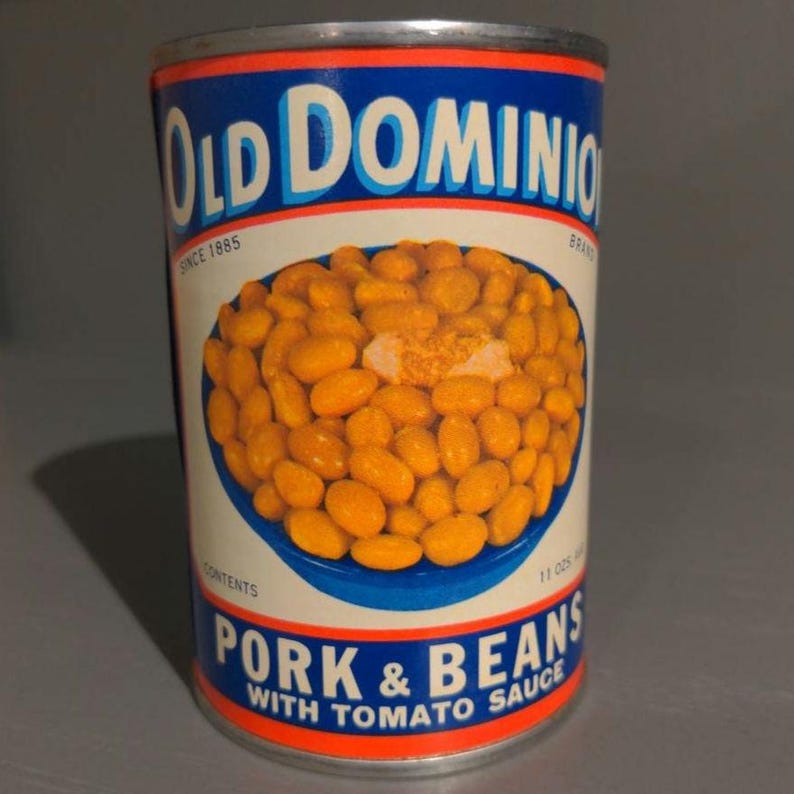 May include: A vintage can of Old Dominion Brand Pork & Beans with Tomato Sauce. The can is blue and red with a picture of beans in tomato sauce.