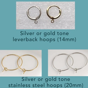 May include: Two pairs of hoop earrings, one pair is silver tone leverback hoops measuring 14mm, the other pair is gold tone stainless steel hoops measuring 20mm.