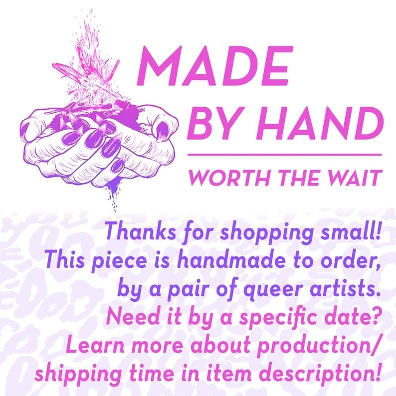 May include: Pink and purple illustration of two hands holding a heart with flames. The text "MADE BY HAND WORTH THE WAIT" is above the hands. The text below the hands reads "Thanks for shopping small! This piece is handmade to order, by a pair of queer artists. Need it by a specific date? Learn more about production/shipping time in item description!"