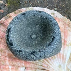 May include: A set of three ceramic mugs with a speckled, matte finish. The mugs are in shades of cream, light gray, and dark gray. Each mug has a simple, minimalist design, perfect for coffee or tea.