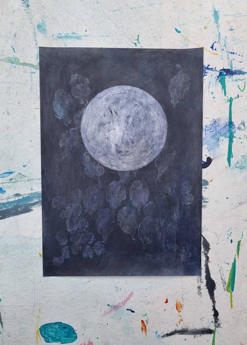 May include: A white circle on a dark gray background with white shapes surrounding it. The circle has a textured surface.