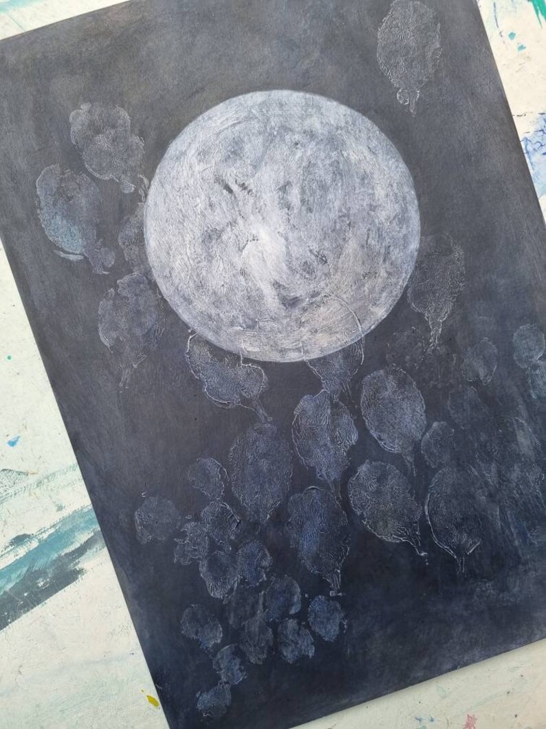 May include: A black canvas with a white circle in the center and white leaf-shaped patterns around it.