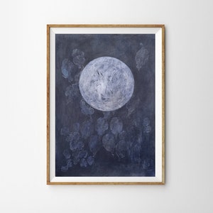 May include: A framed illustration of a large, white moon with a textured surface against a dark blue background. The moon is surrounded by smaller, white, textured shapes that resemble leaves.