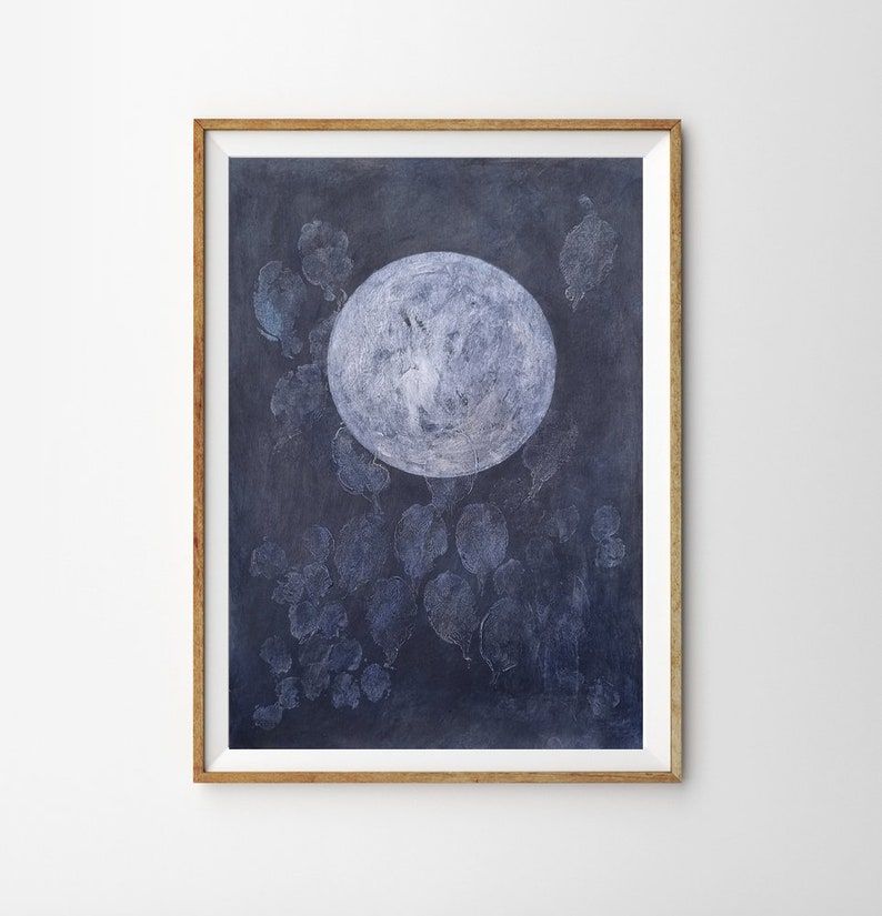 May include: A framed illustration of a large, white moon with a textured surface against a dark blue background. The moon is surrounded by smaller, white, textured shapes that resemble leaves.