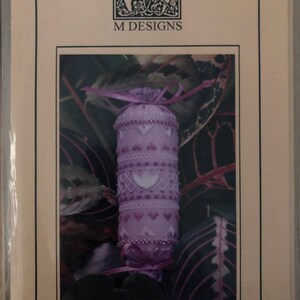 May include: A purple and white needle roll with a heart design and the text "CHERUB NEEDLE ROLL NR#05".