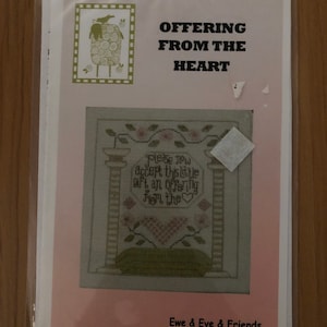 May include: A cross stitch pattern featuring a heart with flowers and the text "Please now accept this little gift an offering from the heart". The pattern is titled "Offering from the Heart" and is by Ewe & Eye & Friends, a new twist to Twisted Threads.