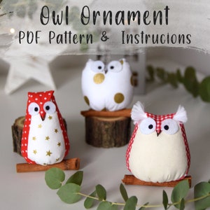 May include: Three handmade owl ornaments, one white with gold polka dots, one red and white with white stars, and one white with red and white gingham. Each owl is sitting on a cinnamon stick.