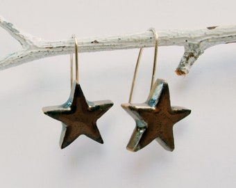 Sterling silver hooks. Ceramic earrings handmade in France. Black stars dangle earrings.