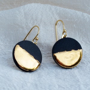 Black and gold ceramic earrings. Porcelain disc and gold plated surgical steel ear hooks. Minimalist earrings handmade in France. image 3