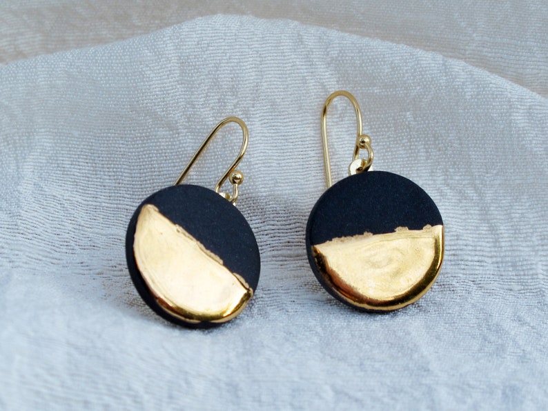 Black and gold ceramic earrings. Porcelain disc and gold plated surgical steel ear hooks. Minimalist earrings handmade in France. image 3