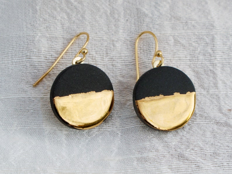 Black and gold ceramic earrings. Porcelain disc and gold plated surgical steel ear hooks. Minimalist earrings handmade in France. image 5