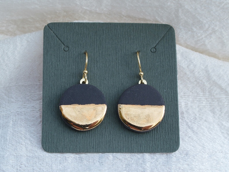 Black and gold ceramic earrings. Porcelain disc and gold plated surgical steel ear hooks. Minimalist earrings handmade in France. image 2