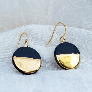 Black and gold ceramic earrings. Porcelain disc and gold plated surgical steel ear hooks. Minimalist earrings handmade in France. image 1