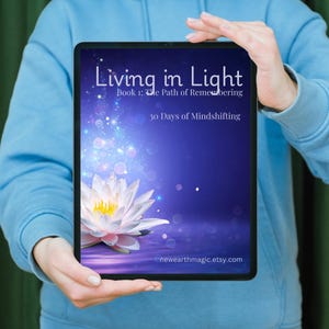 May include: A tablet displays the cover of "Living in Light," Book 1: The Path of Remembering, with the subtitle "30 Days of Mindshifting." The cover features a white lotus flower and a purple and blue background. The Etsy shop URL is visible at the bottom.