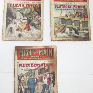 May include: Three vintage pulp fiction magazine covers from the Might and Main Library series. The covers feature illustrations of boys in action-packed scenes. The first cover shows a boy falling into a waterfall, the second shows a boy on a raft in a river, and the third shows a group of boys in front of a house.