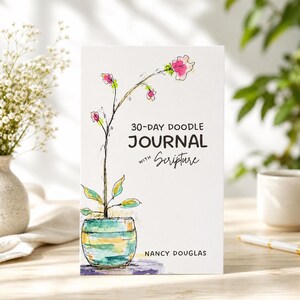 May include: A white journal titled 30-Day Doodle Journal with Scripture by Nancy Douglas. The cover features a watercolor illustration of a plant in a teal and yellow striped pot with pink and green floral accents on a thin, dark stem.