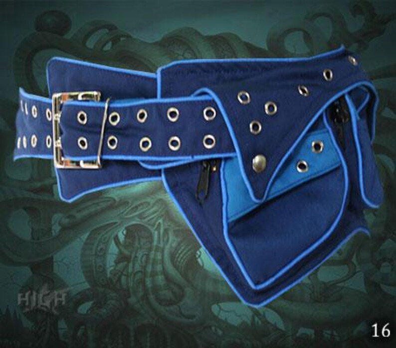 May include: A blue and black canvas belt with a large pocket and multiple zippered compartments. The belt has a buckle and grommets along the edge.