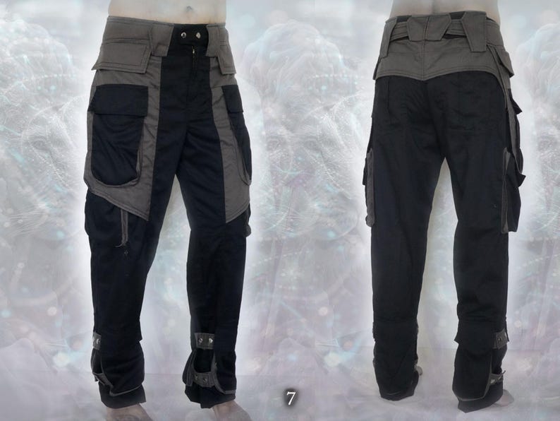 May include: Black and gray cargo pants with multiple pockets and a belt. The pants have a unique design with contrasting panels and zippers.