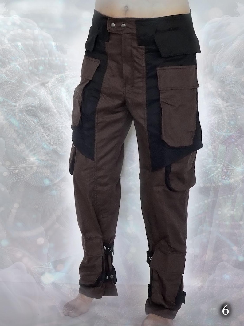 Brown cargo pants with black accents and multiple pockets. The pants have adjustable straps at the bottom of the legs.